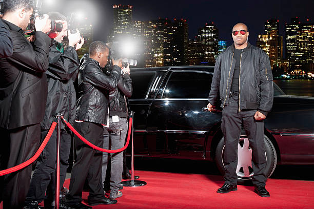 Bodyguard opening limo door on red carpet  rich black men pictures stock pictures, royalty-free photos & images