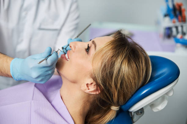 istock Stomatologist performing a check of teeth with dental tools 1304071389
