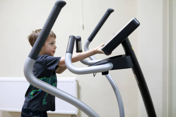 istock Child exercising at stride treadmill 1304072839