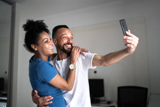 istock Couple taking a selfie or doing a video call at home 1304073276