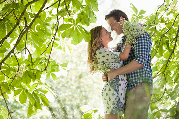 Couple hugging in forest  flower outdoors day loving stock pictures, royalty-free photos & images