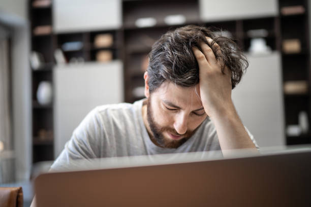 istock Tired and worried man working from home 1304075092