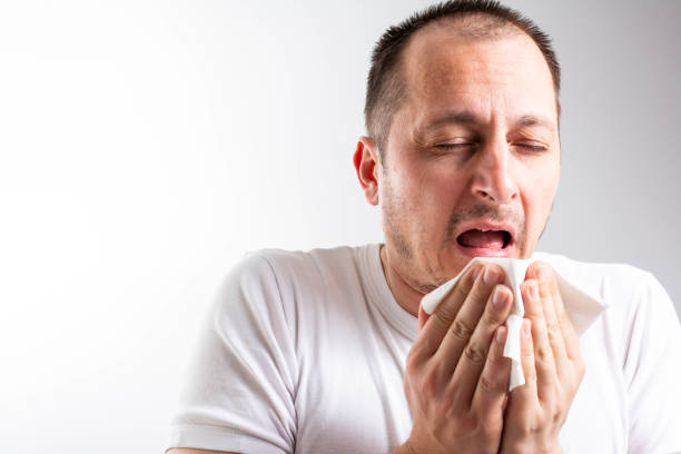 istock Virus or influenza. Sick guy cleaning his snotty nose 1304075097
