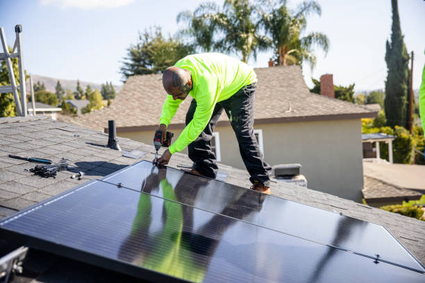 istock Mexican Man Drilling Solar Panel to Roof 1304075284