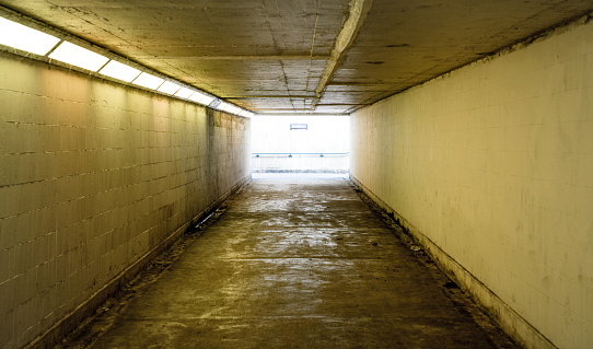 A view along an empty old underground tunnel for pedestrians.