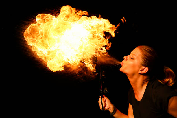 큰 불꽃을 불고 여성 화재 먹는 사람 - fire eater fire performance circus performer 뉴스 사진 이미지