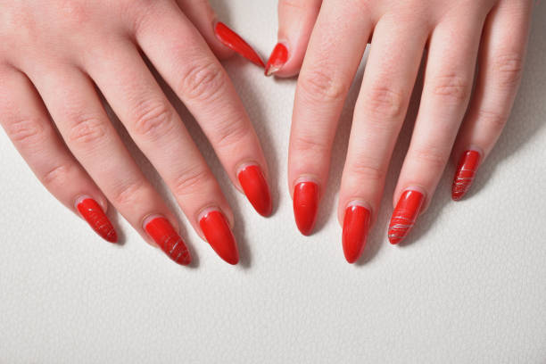 istock Female hands with regrown red gel nails close-up 1304076674