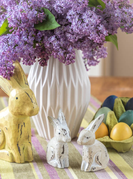 istock Lilac in a vase, bunnies and eggs as easter decoration 1304077811