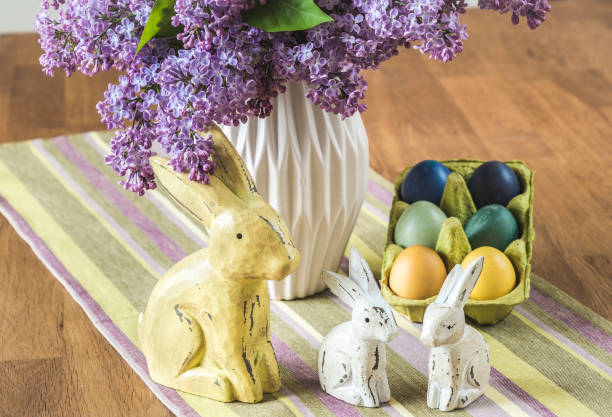 Lilac in a vase, bunnies and eggs as easter decoration