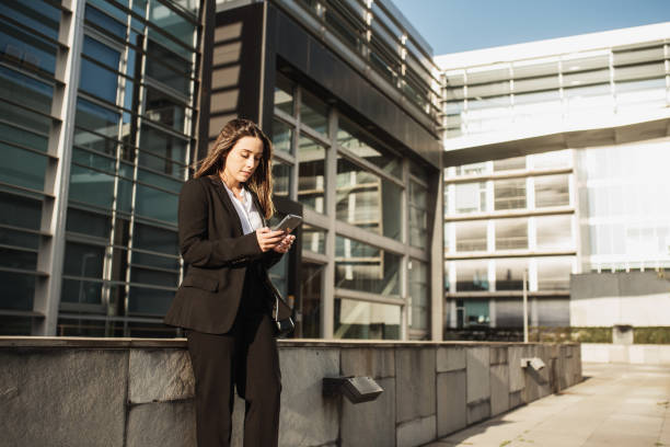 istock Young business woman using a smartphone 1304077901