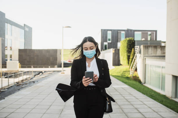 istock Young business woman using a smartphone 1304078020