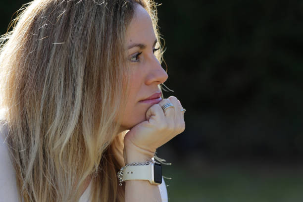 istock woman face portrait outdoors with sun light 1304078054