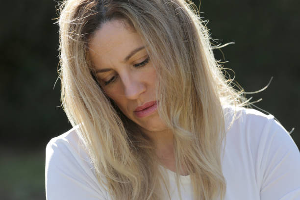 istock woman face portrait outdoors with sun light 1304078067