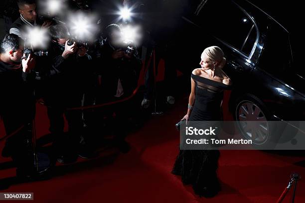 Celebrity Posing For Paparazzi On Red Carpet Stock Photo - Download Image Now - Red Carpet Event, Celebrities, Fame