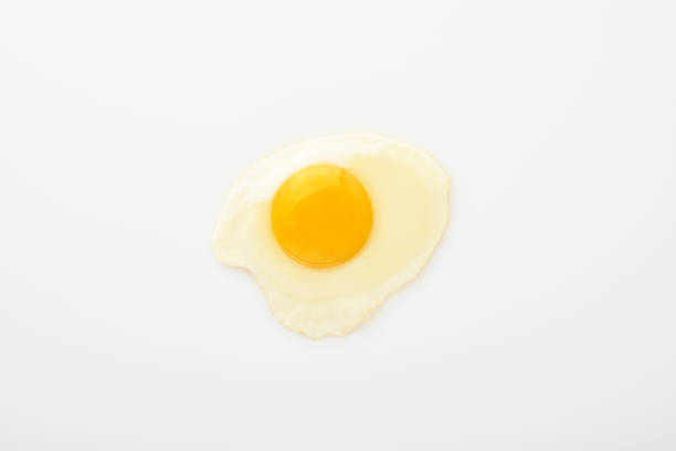istock One fried egg isolated on white background with clipping path. Top view. 1304078405