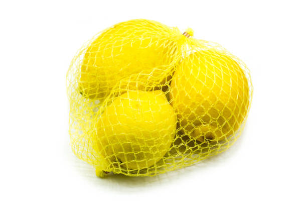 istock Lemons in the net isolated on white background 1304079369