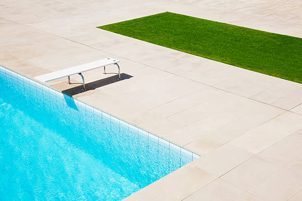 Diving board over pool  diving board stock pictures, royalty-free photos & images