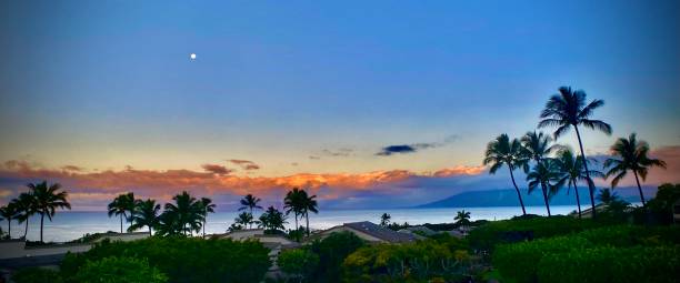 istock vivid sunrise on maui with a full wolf moon / wide angle view 1304080296