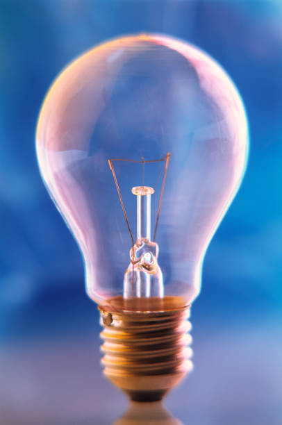istock Electric incandescent lamp on a blue blurred background, close-up. 1304081068