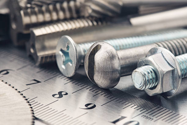 istock set of different nuts, bolts, screws, washers and drill bits,thread tap and mill cutters on steel plate background. Locksmithing deal. 1304081928