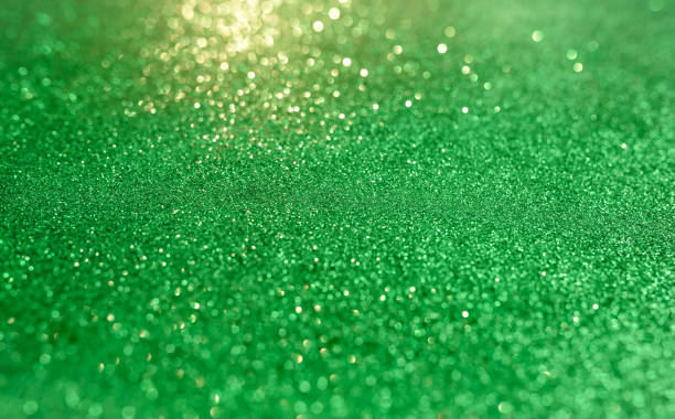 istock Green blurred background with highlights and fine texture of shiny crystals 1304081989