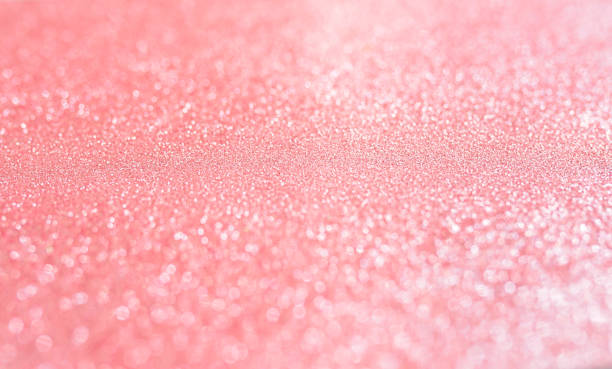 istock Pink blurred background with highlights and fine texture of shiny crystals 1304082036