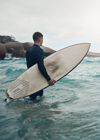 Silhouette of a man surfing on a sea wave in Puerto Escondido Oaxaca