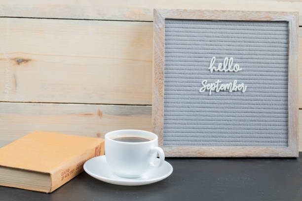 istock Hello september poster embedded on grey background with a cup of drink aside 1304083480