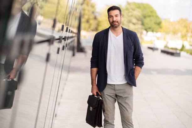 istock Modern businessman looking at the camera while standing outside 1304083843