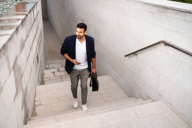 istock Young businessman moving upstairs while going to work 1304083866
