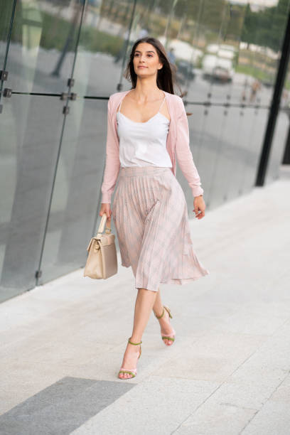 Confident young woman walking Modern young Caucasian businesswoman on her way to work. business casual fashion stock pictures, royalty-free photos & images