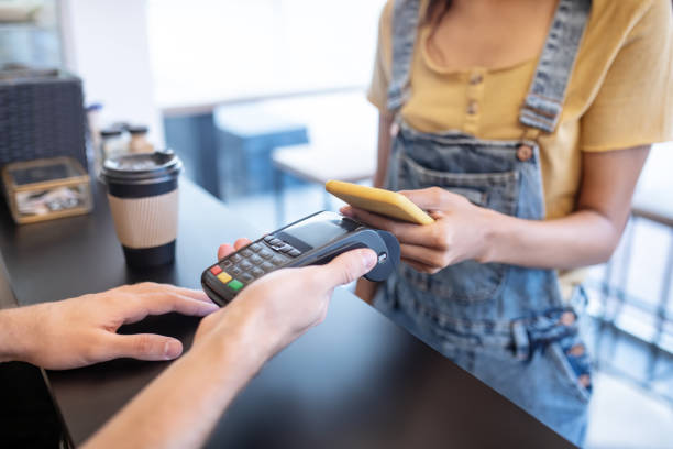 istock Female hands holding smartphone near poster 1304084065