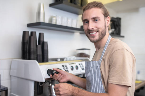 istock Busy happy man pouring water for coffee 1304084078