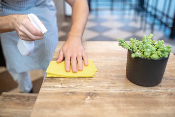 istock Male hands wiping table surface in cafe 1304084184