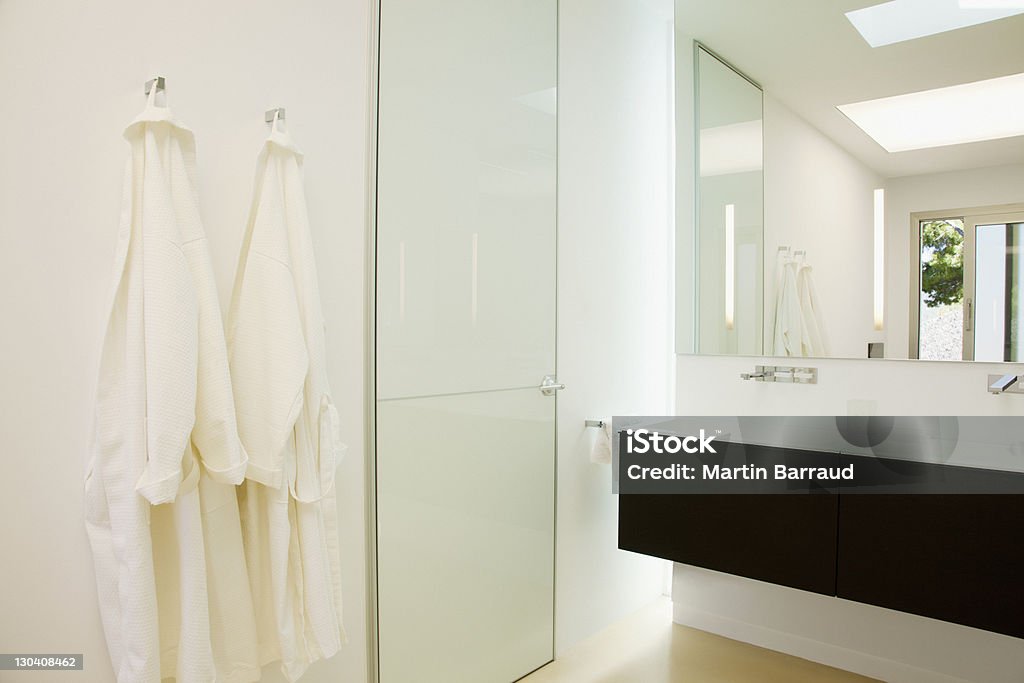Batas colgadas en el baño moderno - Foto de stock de Albornoz libre de derechos