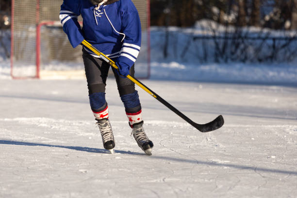 istock Playing ice hockey outdoors on lake 1304086342