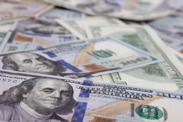 istock Bundle of dollars on the table close-up - texture, background 1304086424
