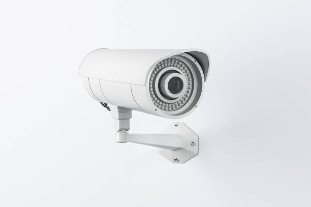 istock Outdoor monitoring concept with white CCTV security camera on light wall 1304086524