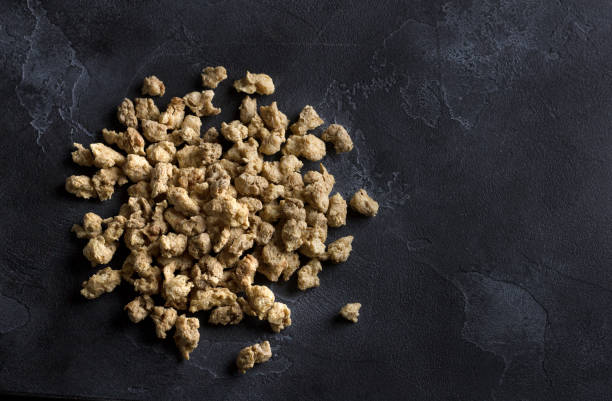 istock Dried soy meat on black textured background 1304088086