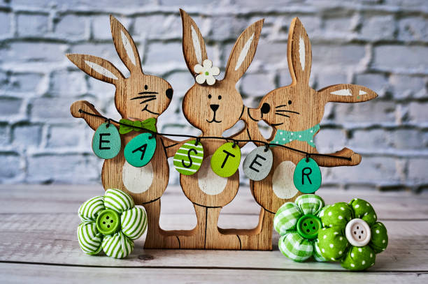 istock Three wooden Easter bunnies with decoration. 1304089539