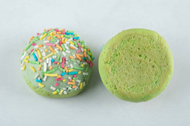 istock Green cookies with sprinkles on white background 1304093808