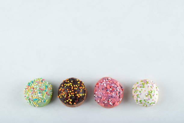 istock Colorful cookies decorated with sprinkles on white background 1304094220