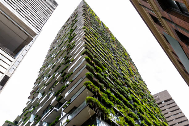 istock Low angle view of appartment building with vertical garden, background with copy space 1304094366