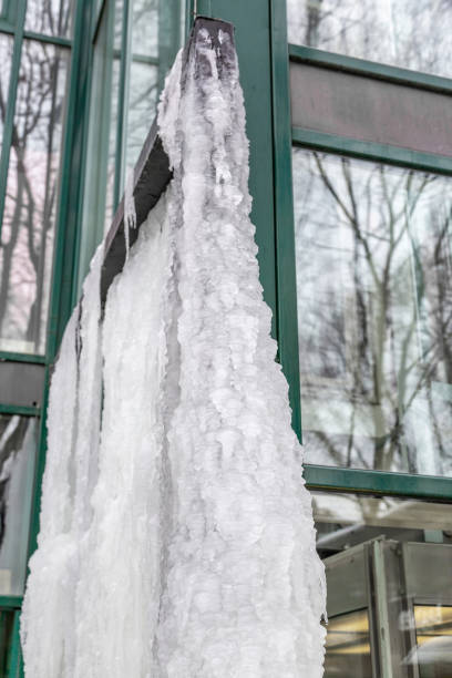istock Icicles on the cornice of the glass building 1304094482