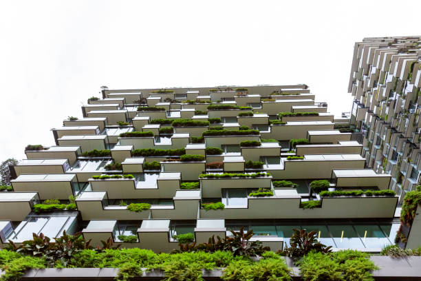 istock Low angle view of appartment buildings with vertical garden, background with copy space 1304095131