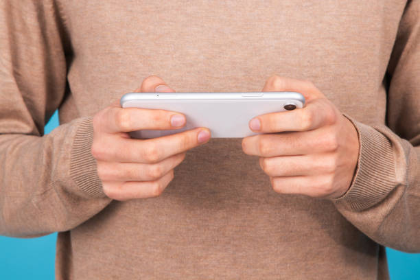 istock close-up of hands with mobile phone 1304095658
