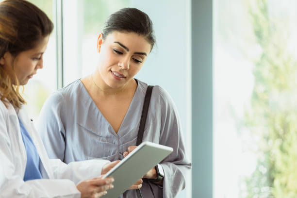 istock Attentive patient discusses lab report with doctor 1304095871
