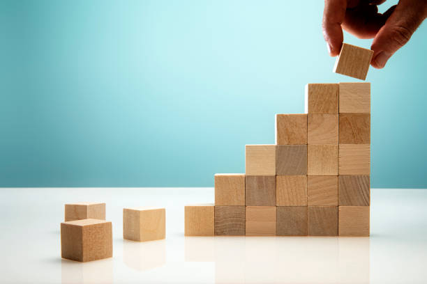 istock Blocks on Blue Background symbolizing Business Growth 1304095893