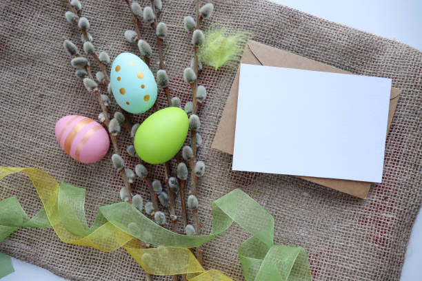 istock easter eggs, willow twigs, flowers and white blank for text 1304099073