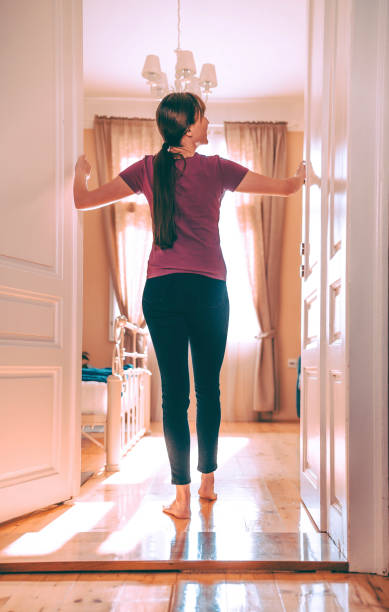 istock Woman opening interior door 1304099180